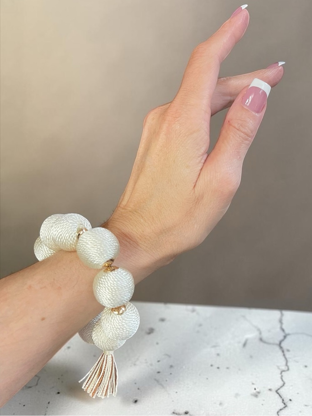 Cream Cord Wrapped Over Sized Bead Tassel Stretch Bracelet